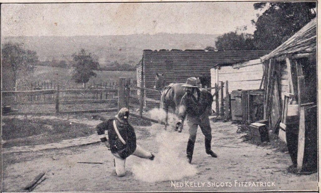 Ned Kelly shoots Fitzpatrick. Movie still postcard from The Story of the Kelly Gang (1906). Jim Davidson Australian postcard collection, National Library of Australia (nla.obj-153093673). Out of Copyright.